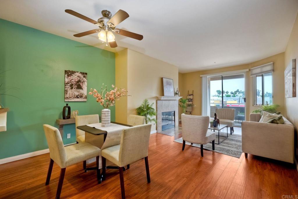 a dining room with furniture a window and wooden floor