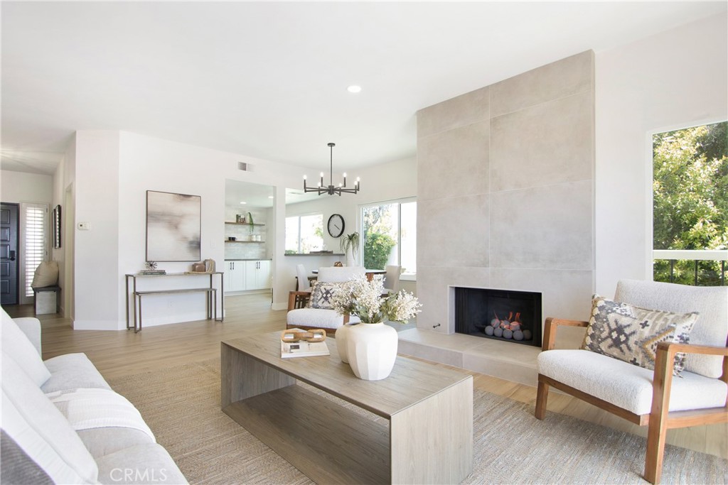 a living room with furniture a fireplace and a table