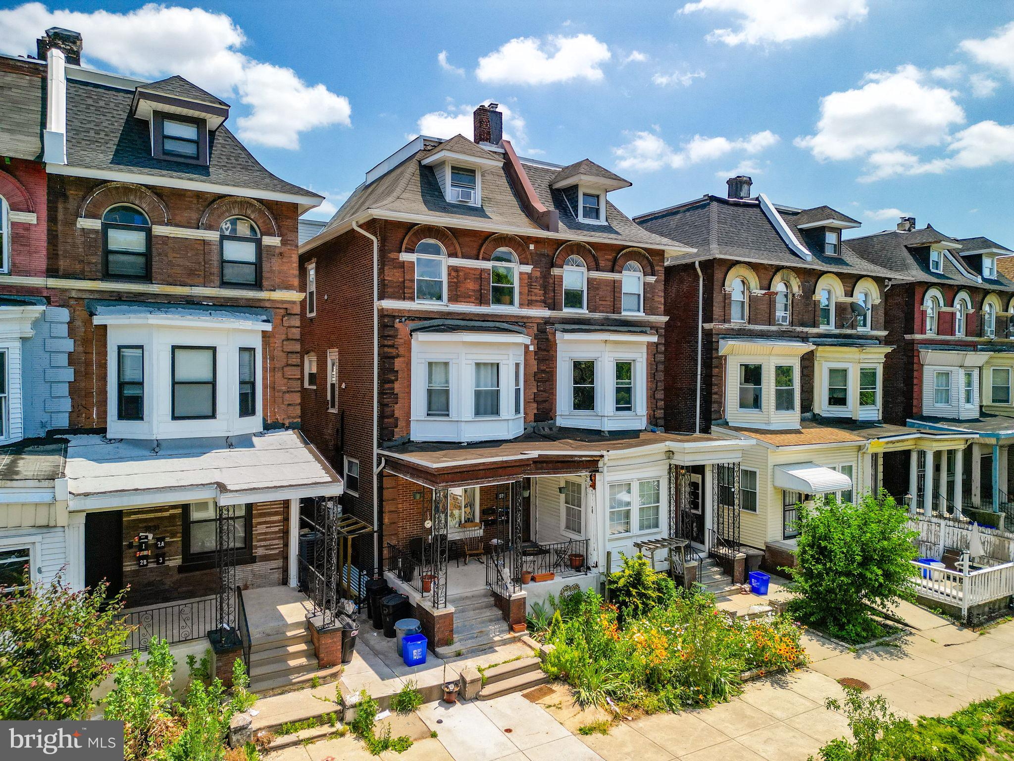 a front view of a residential apartment building with a yard