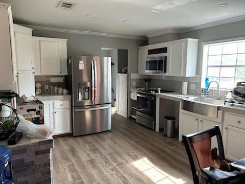 a kitchen with a sink appliances and cabinets