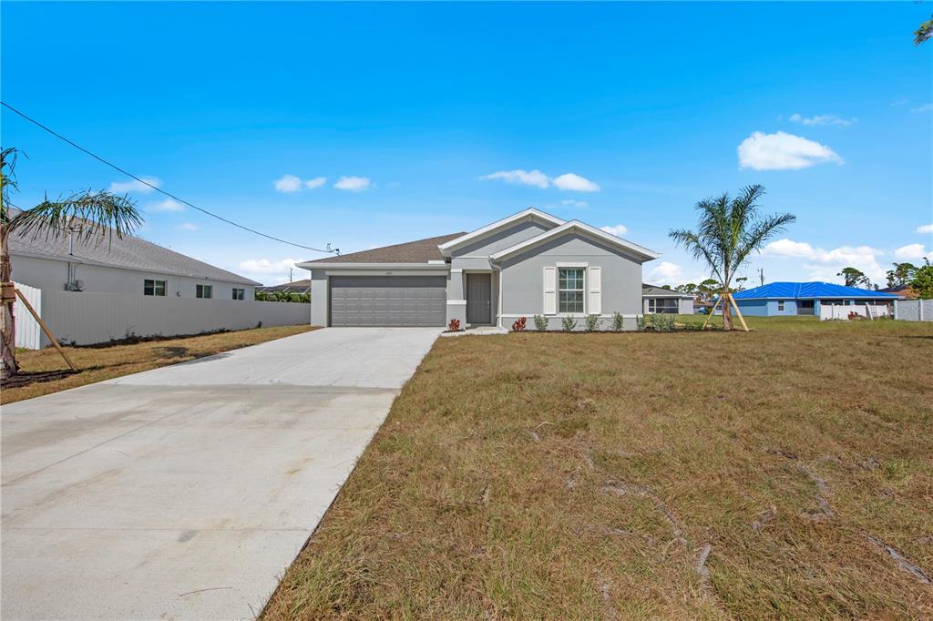 a house with a yard and a wooden fence