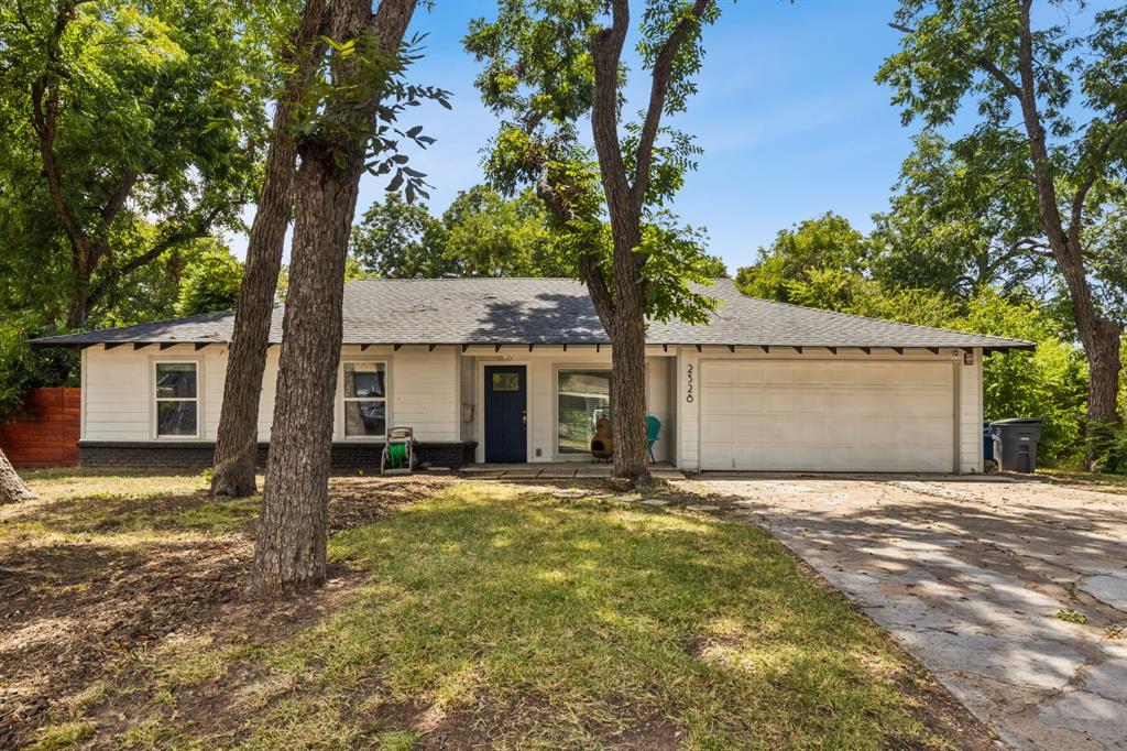 a view of a house with a tree in the background