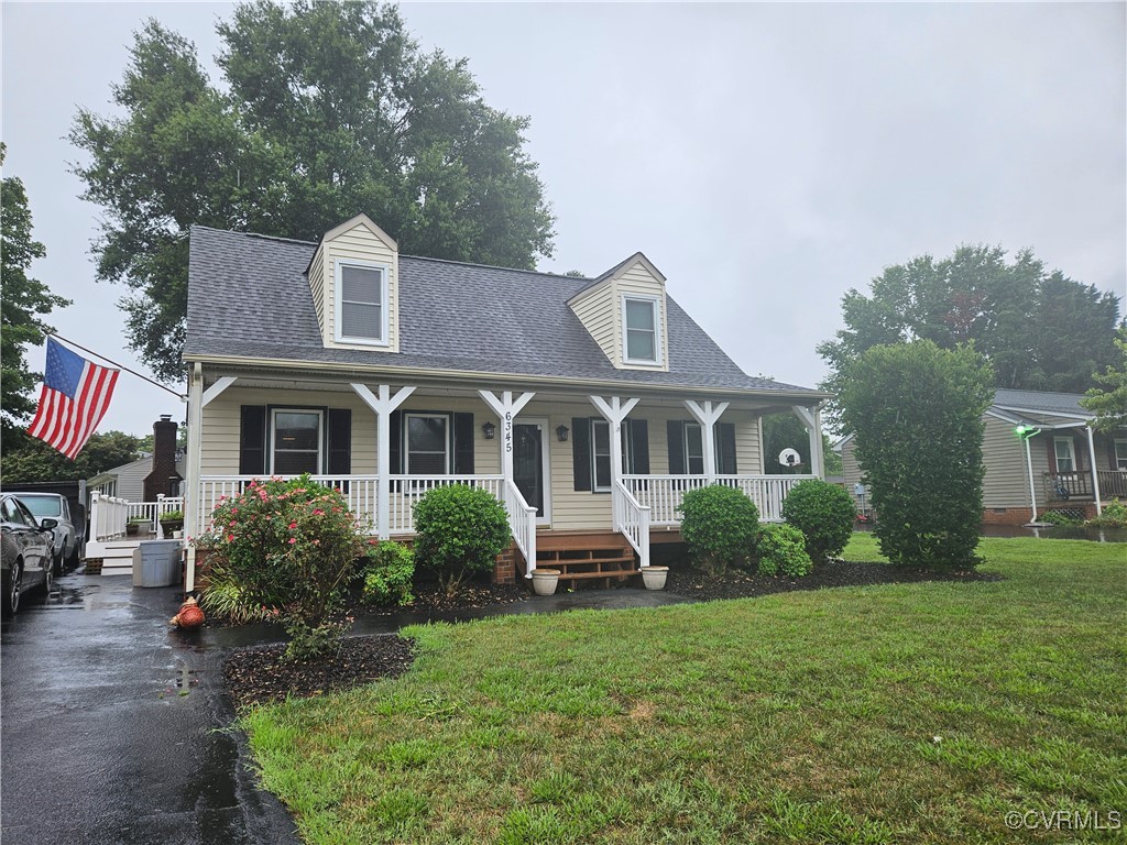 a front view of a house with a yard and trees