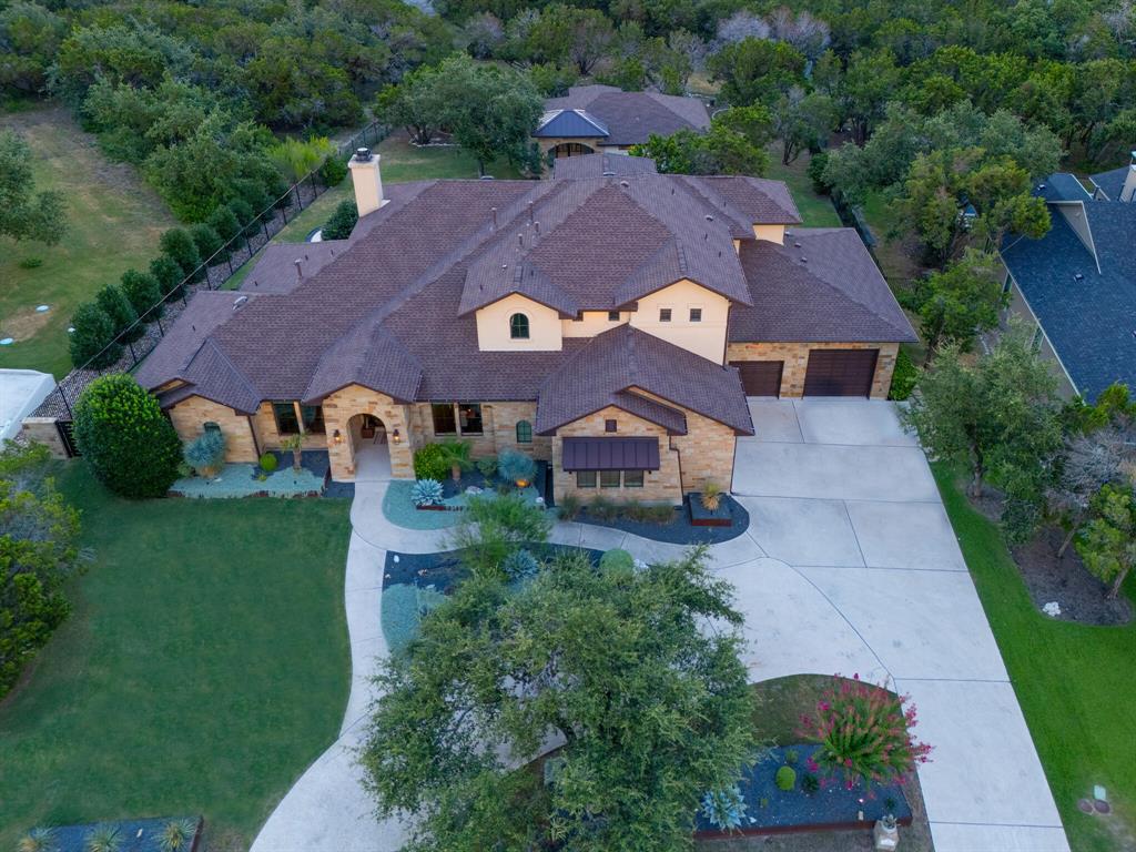 an aerial view of a house with a big yard