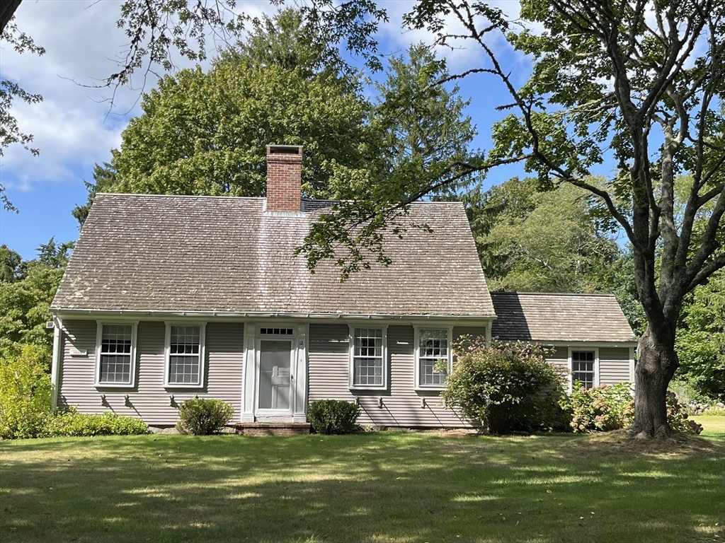 a front view of a house with a garden and plants