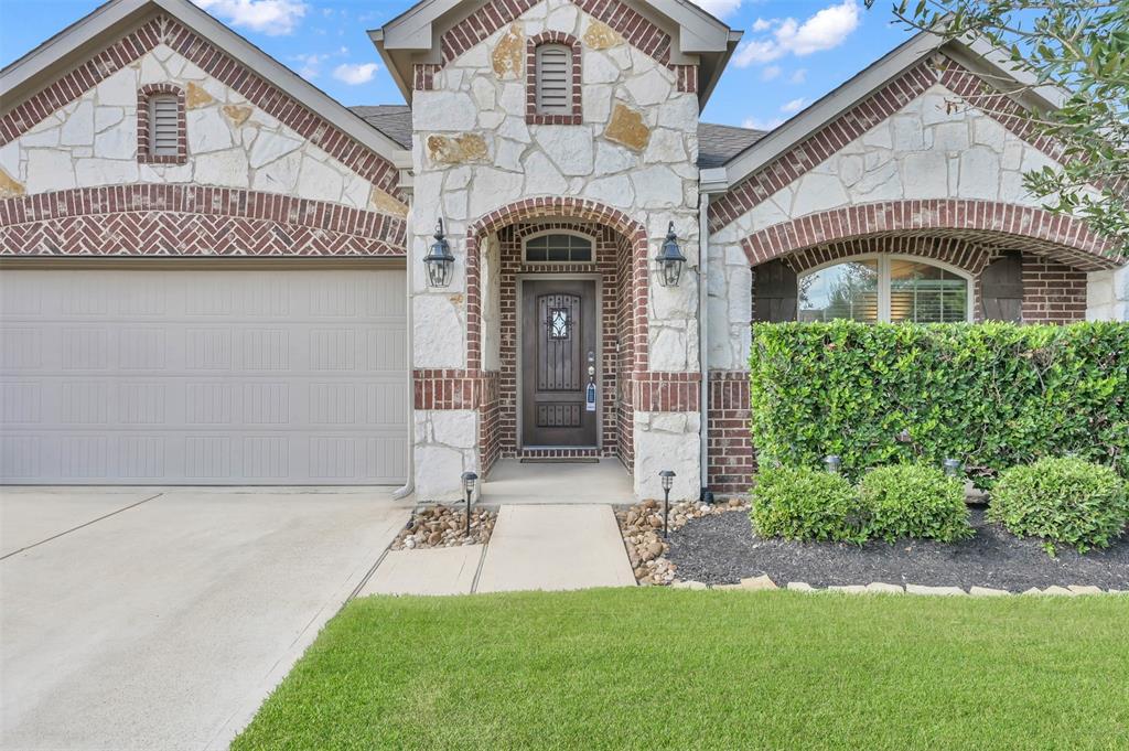 The carriage lights and solid wood door welcome you and your guests home.  And there is brick on all sides of this home.