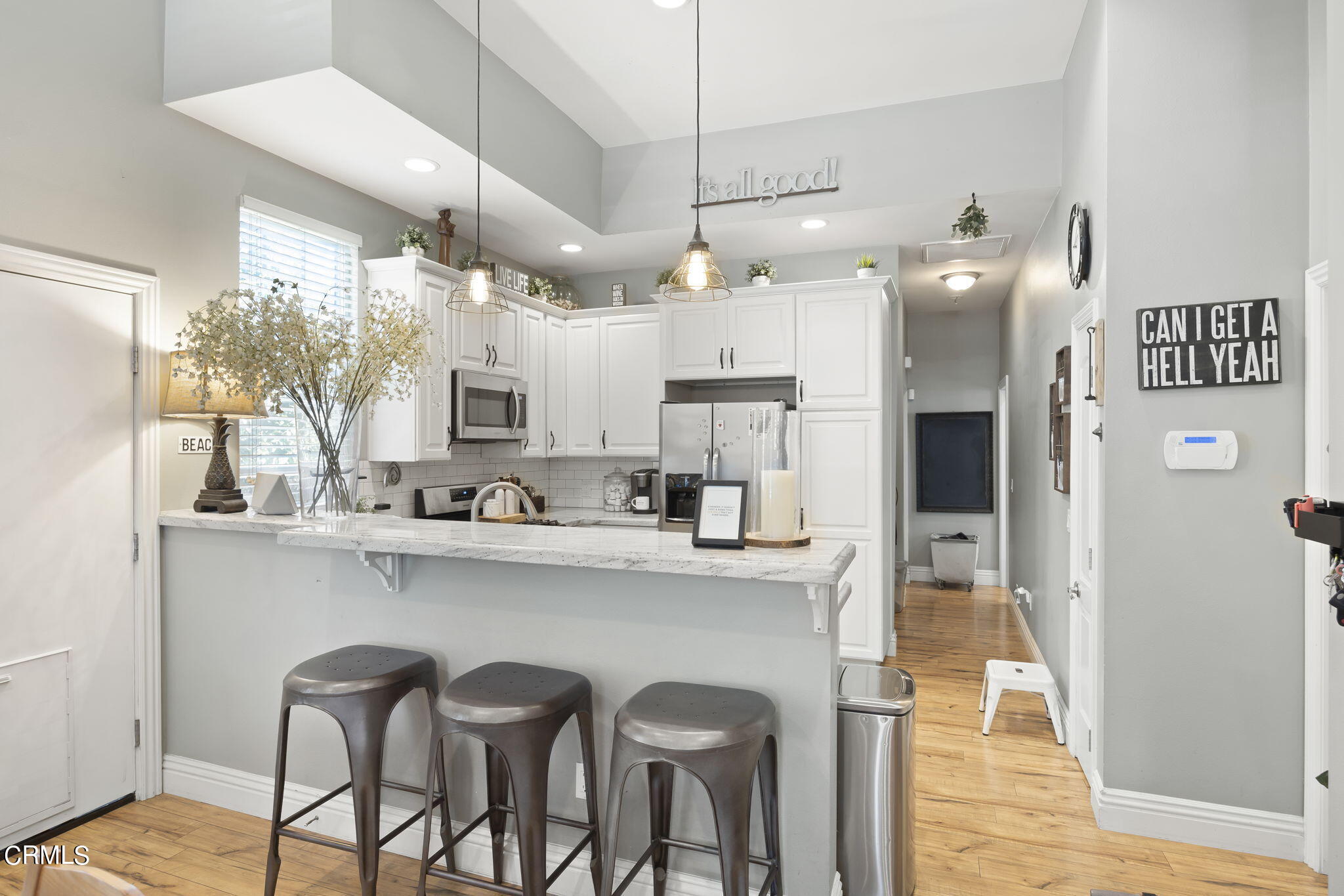 a kitchen with refrigerator and cabinets