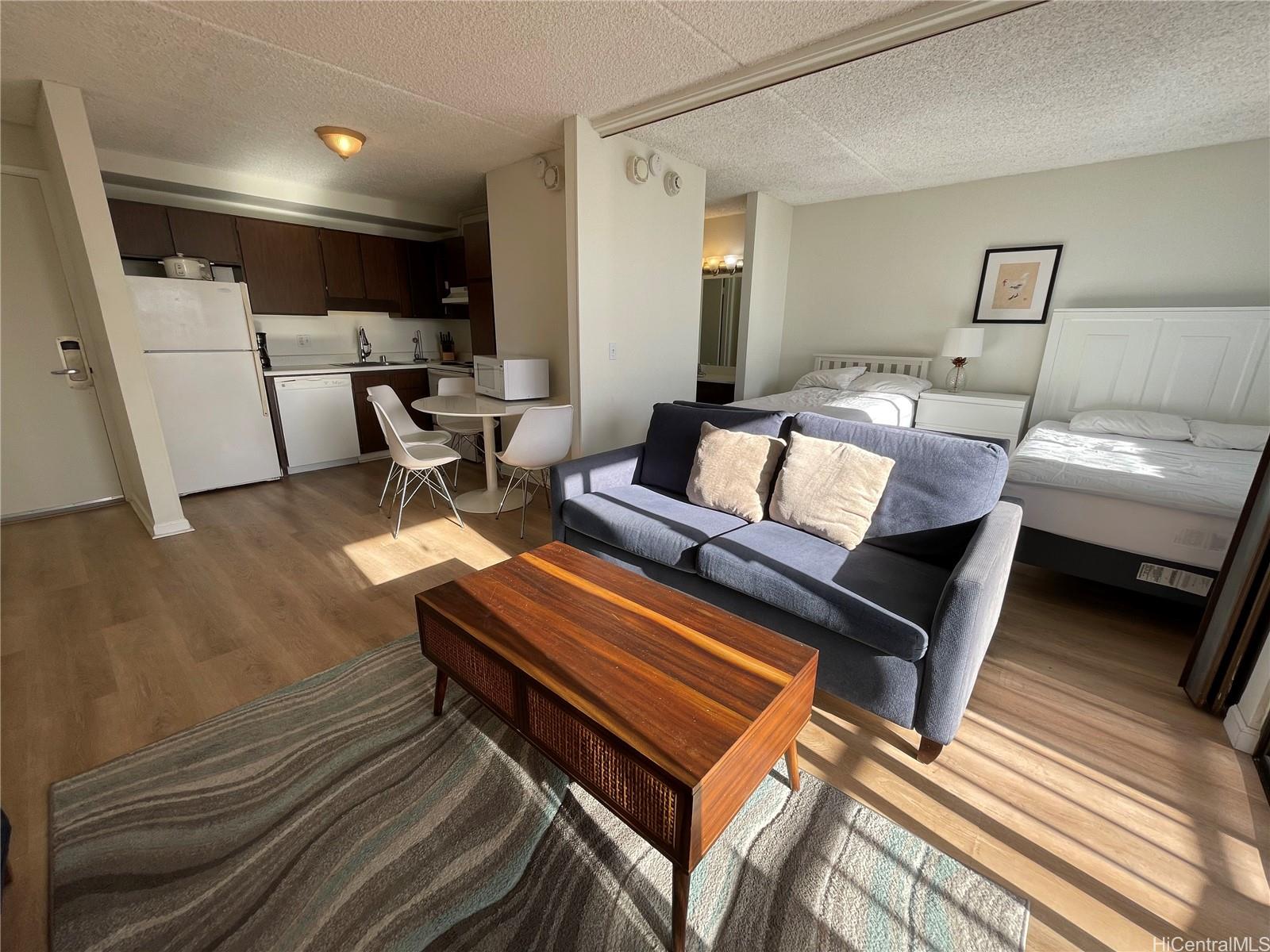 a living room with furniture a rug and a wooden floor