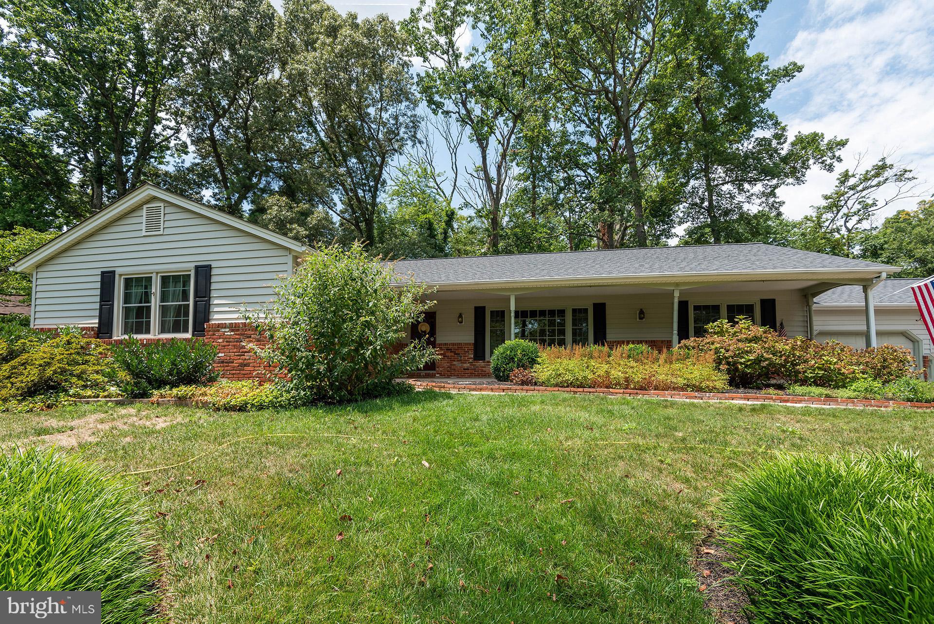 a front view of house with a garden and porch