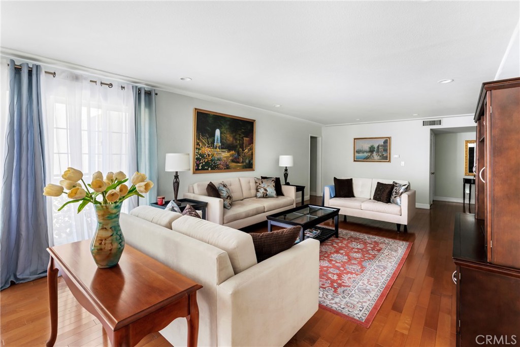 a living room with furniture a flat screen tv and a table