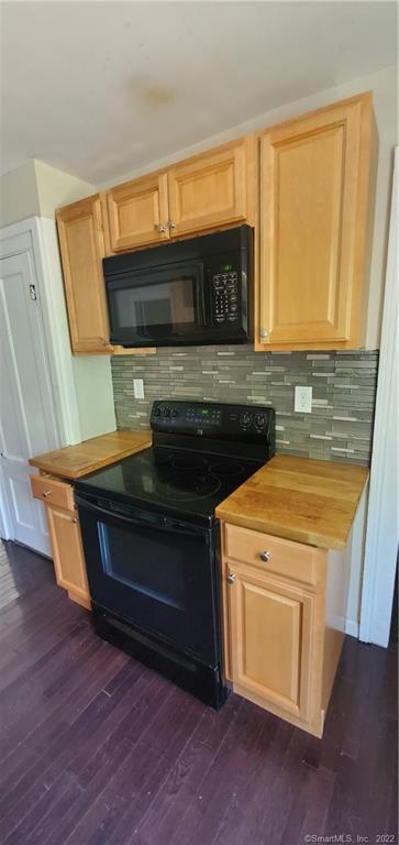 a stove top oven sitting inside of a kitchen