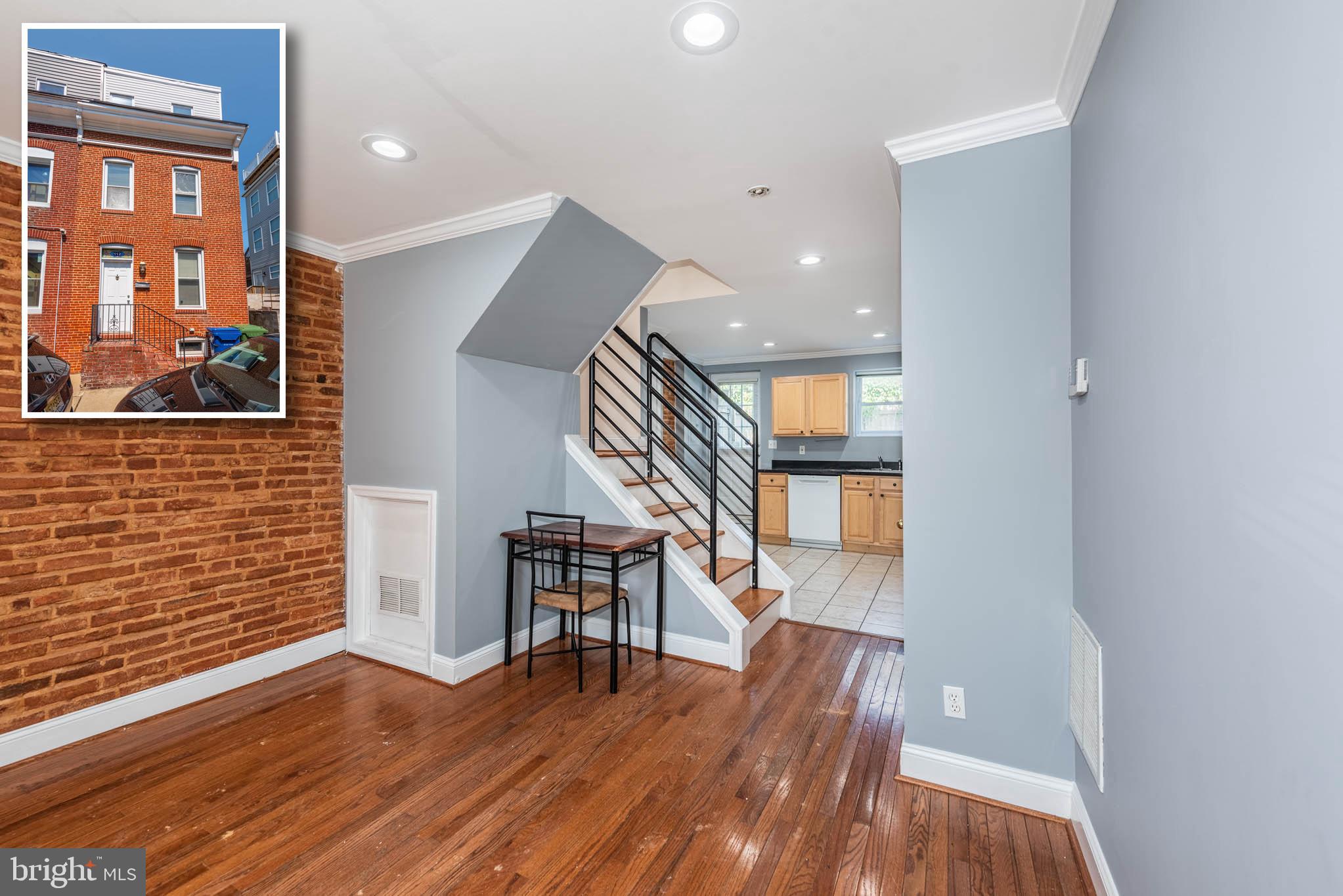 a view of entryway with wooden floor and stairs