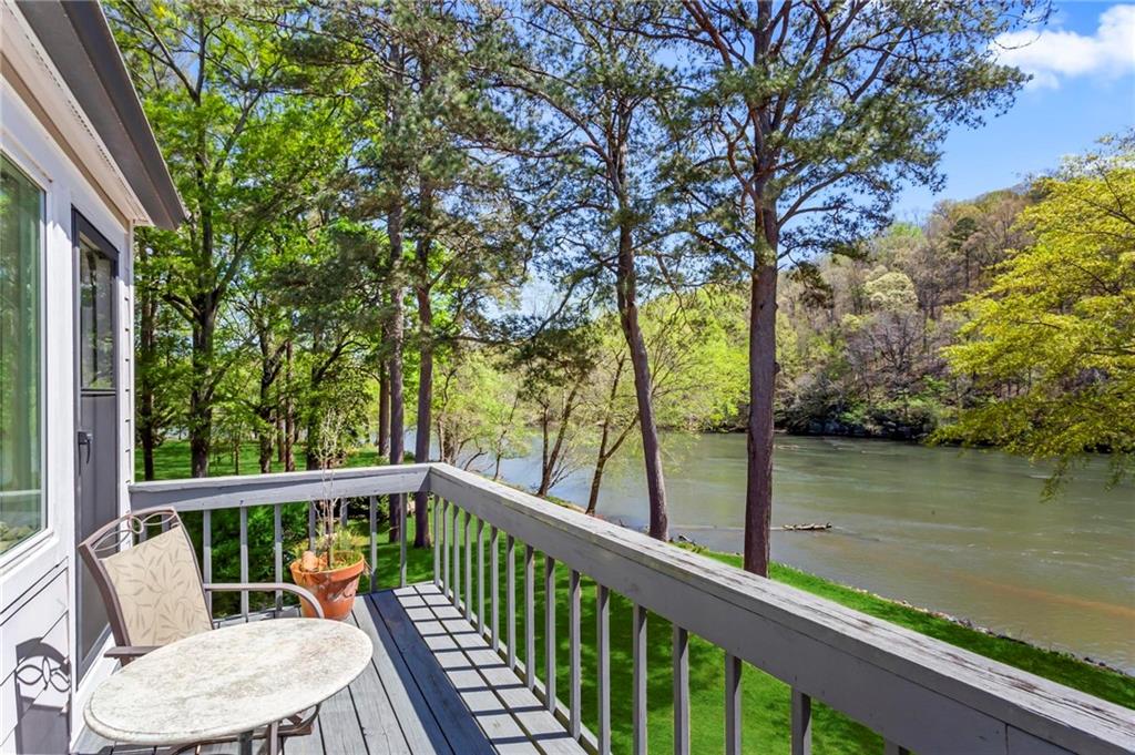 a view of a balcony with lake view and wooden floor