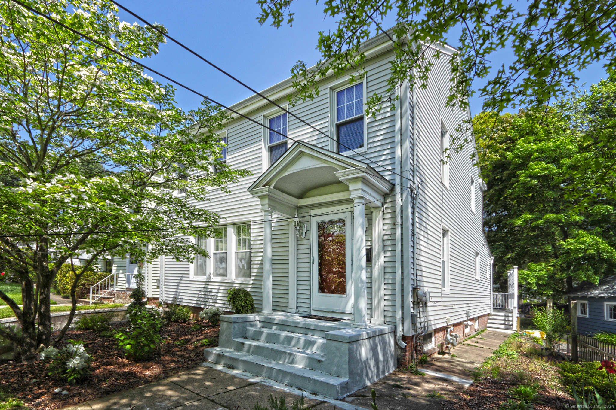 a view of a house with a tree