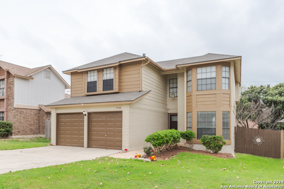 a front view of a house with a yard and garage