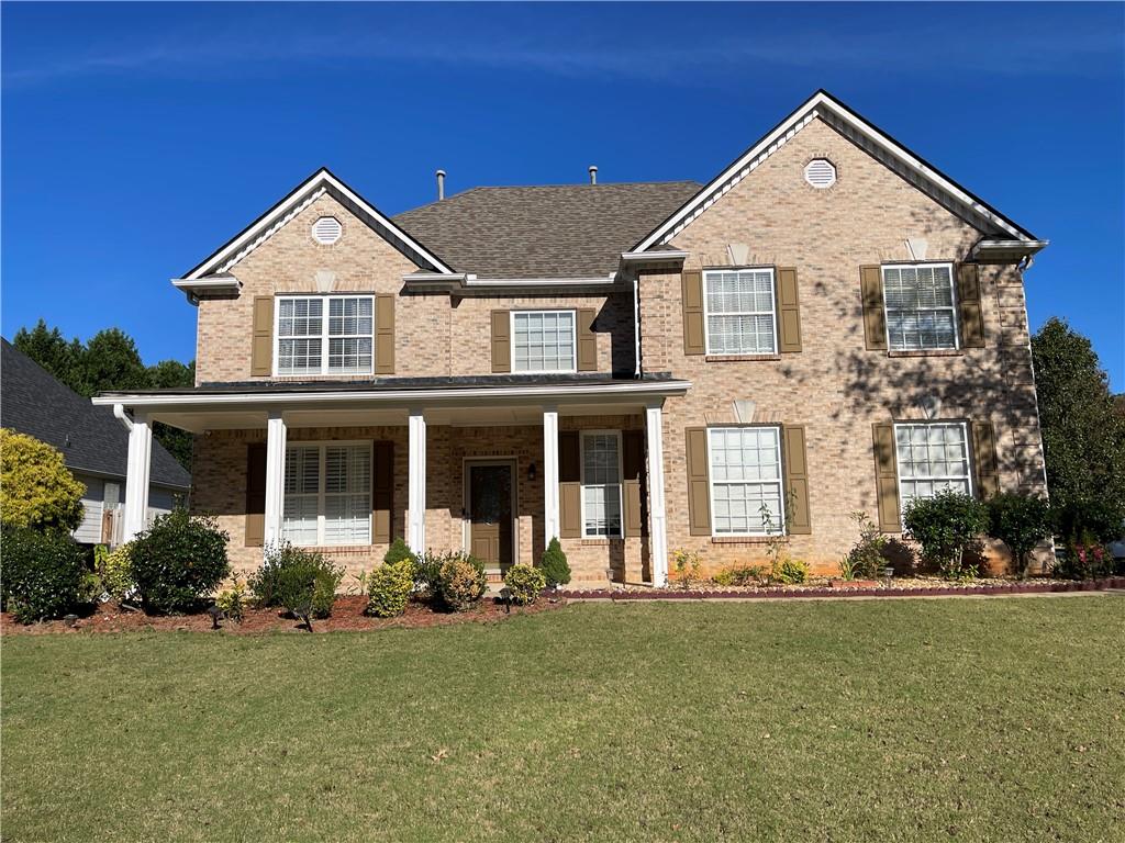 a front view of a house with a yard