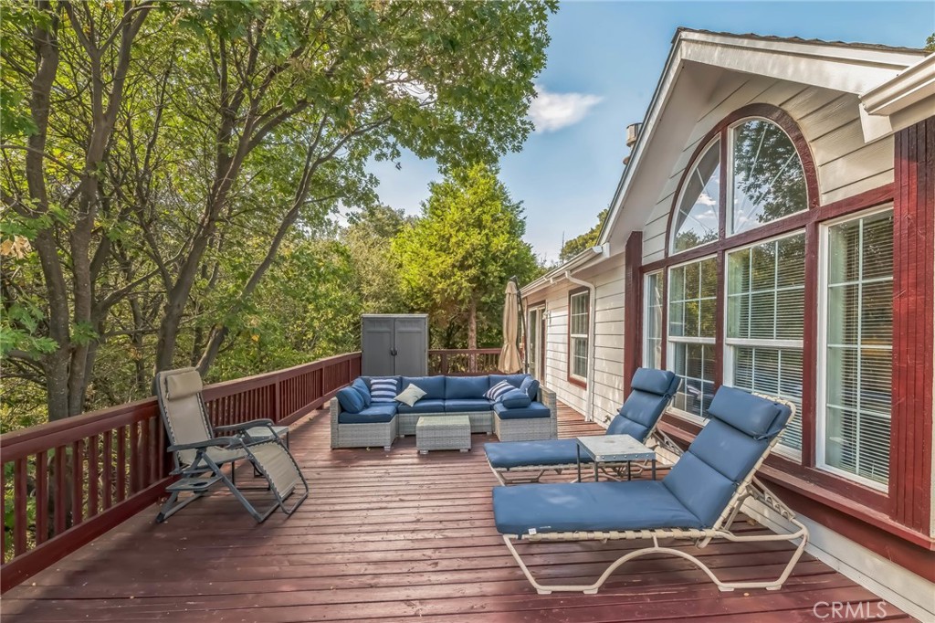 a view of a patio with couches chairs and wooden floor