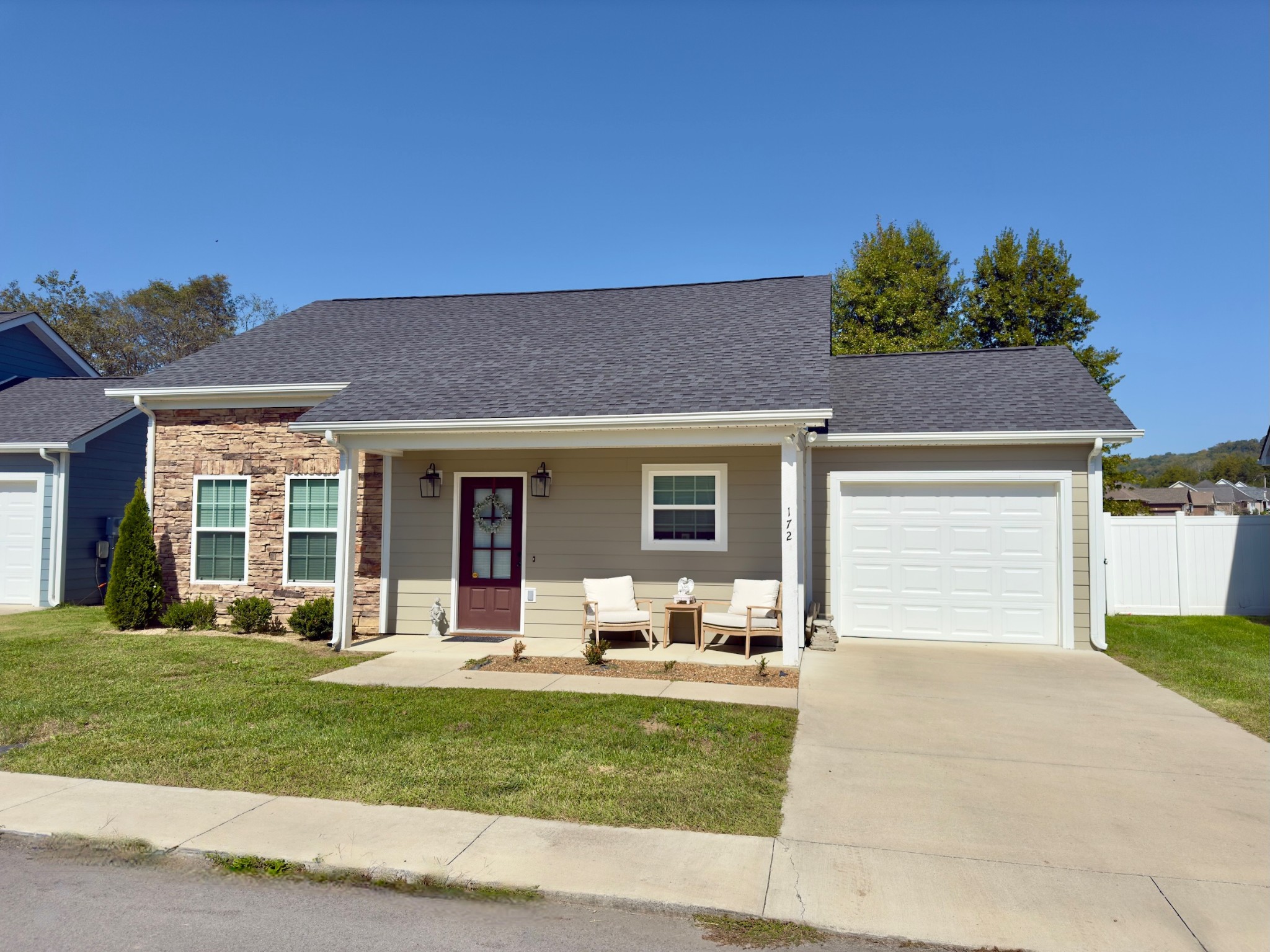 a front view of a house with a yard and outdoor seating