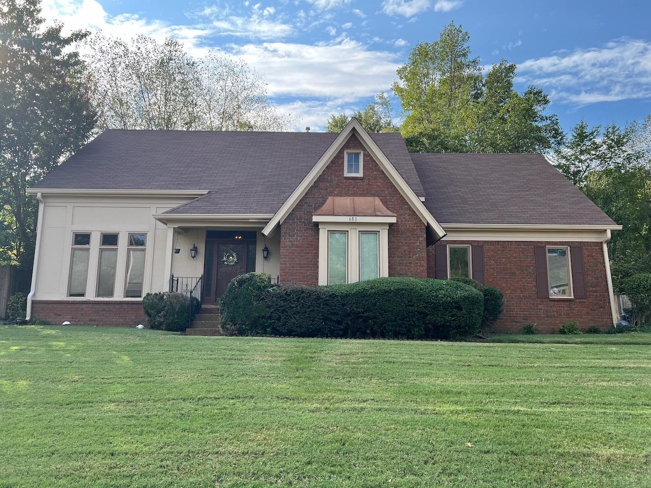 a front view of a house with a yard