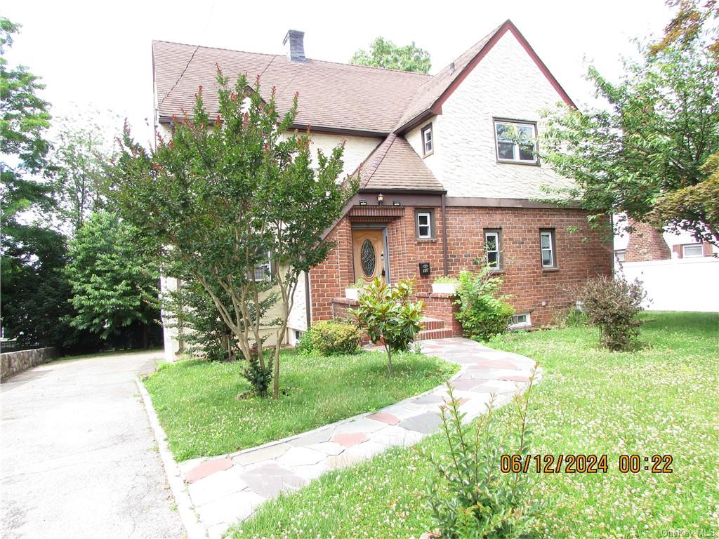 a view of a house with yard and a garden