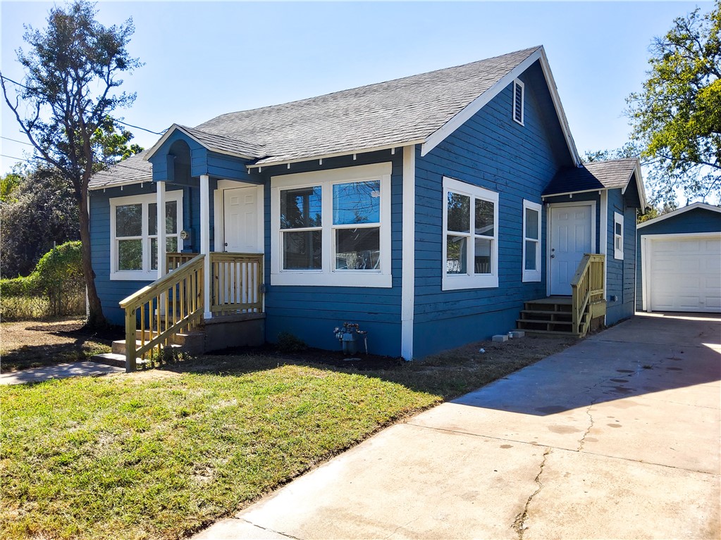 a view of house with yard