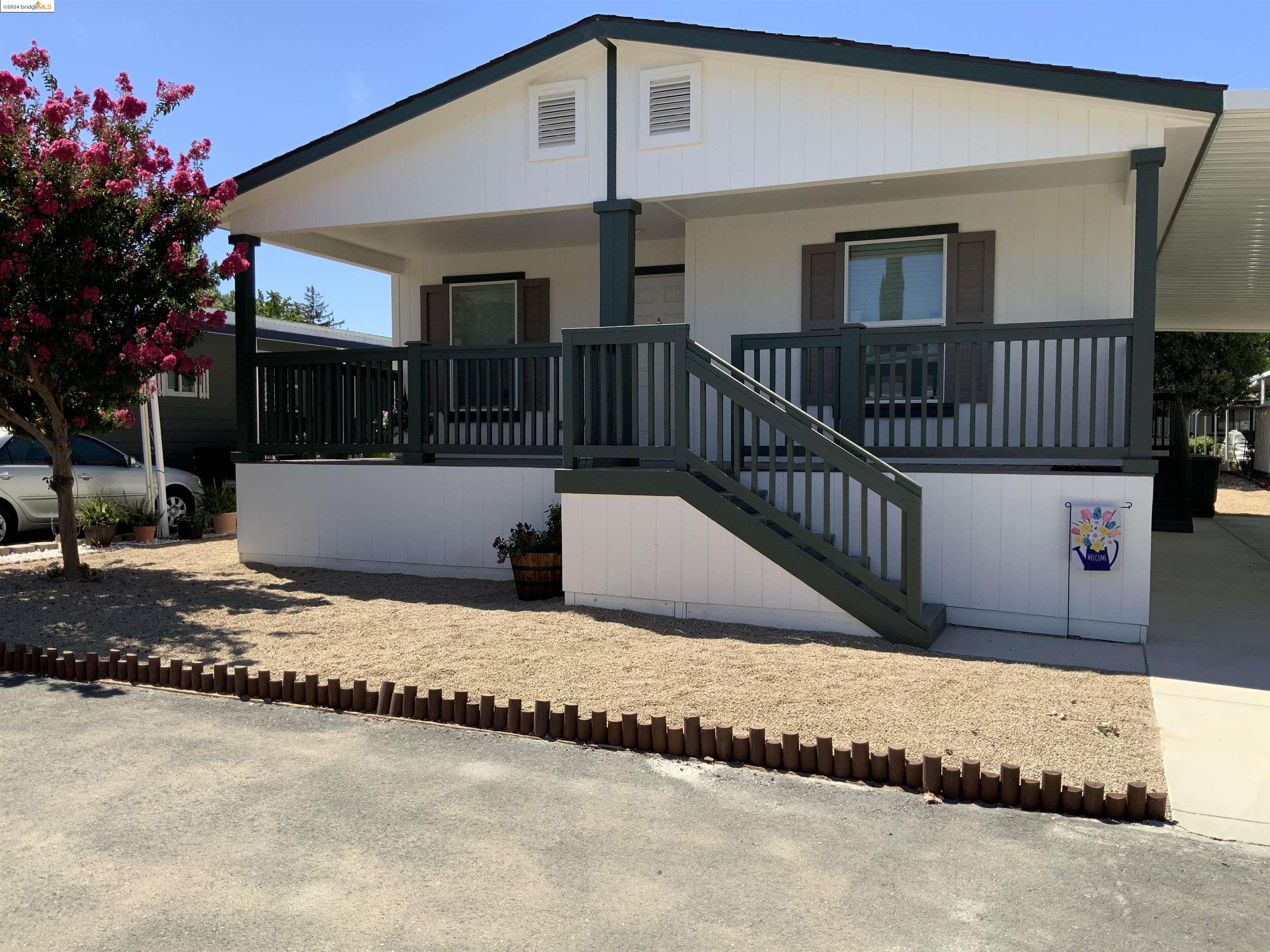 a view of a house with wooden fence