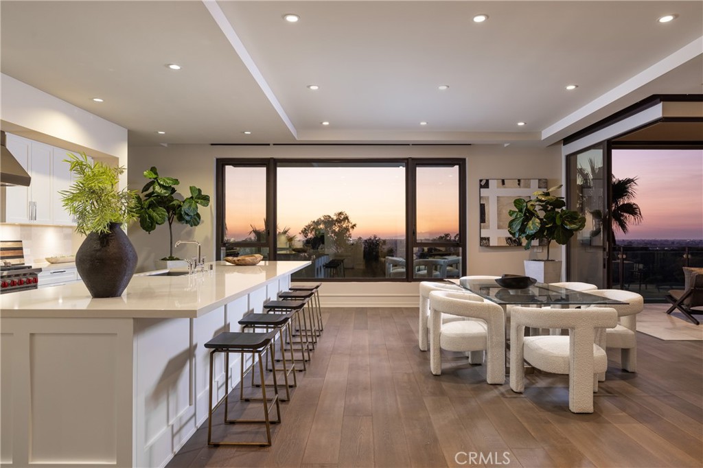 a very nice looking living room with a large dining table and a large window