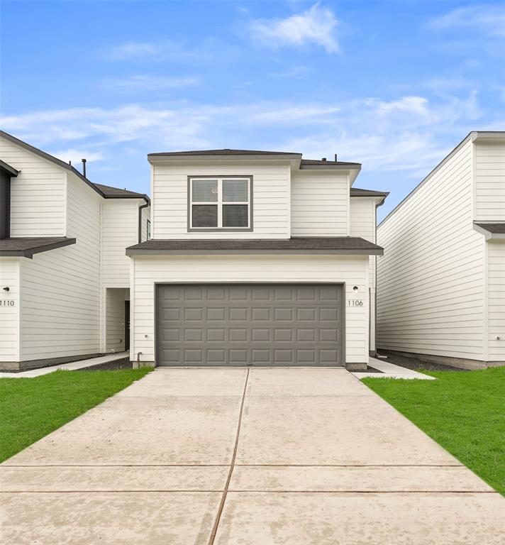 a front view of house with yard garage and yard