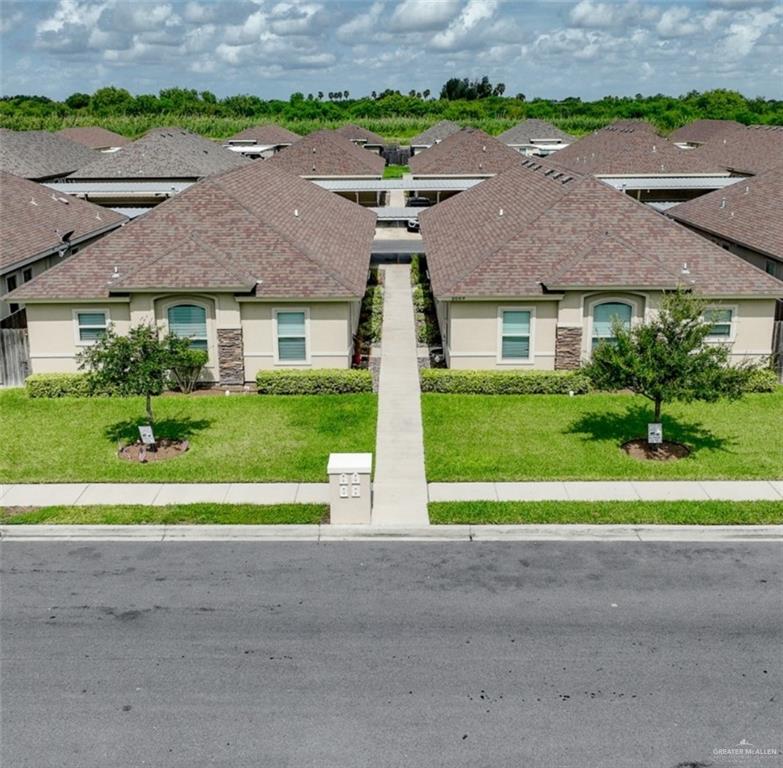 a front view of house with yard and green space