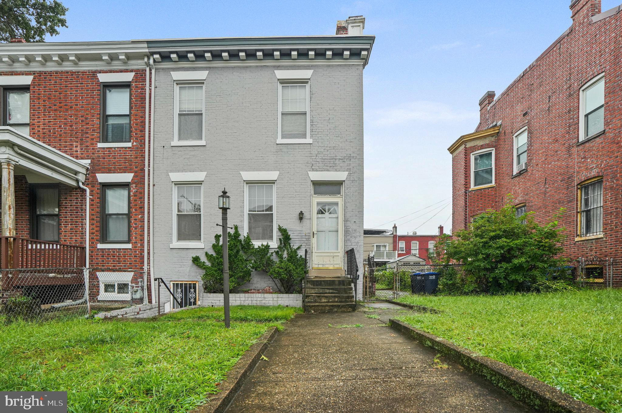 a view of a house with a yard and sitting area