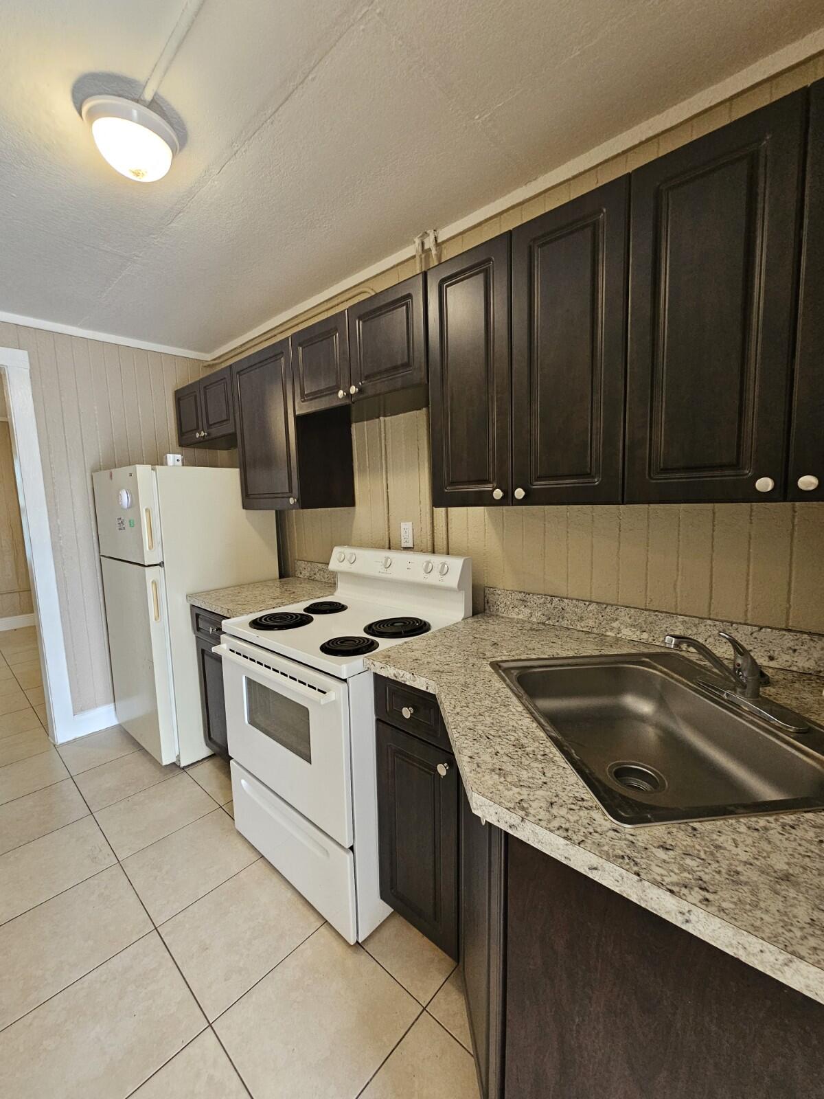 a kitchen with a stove sink and cabinets