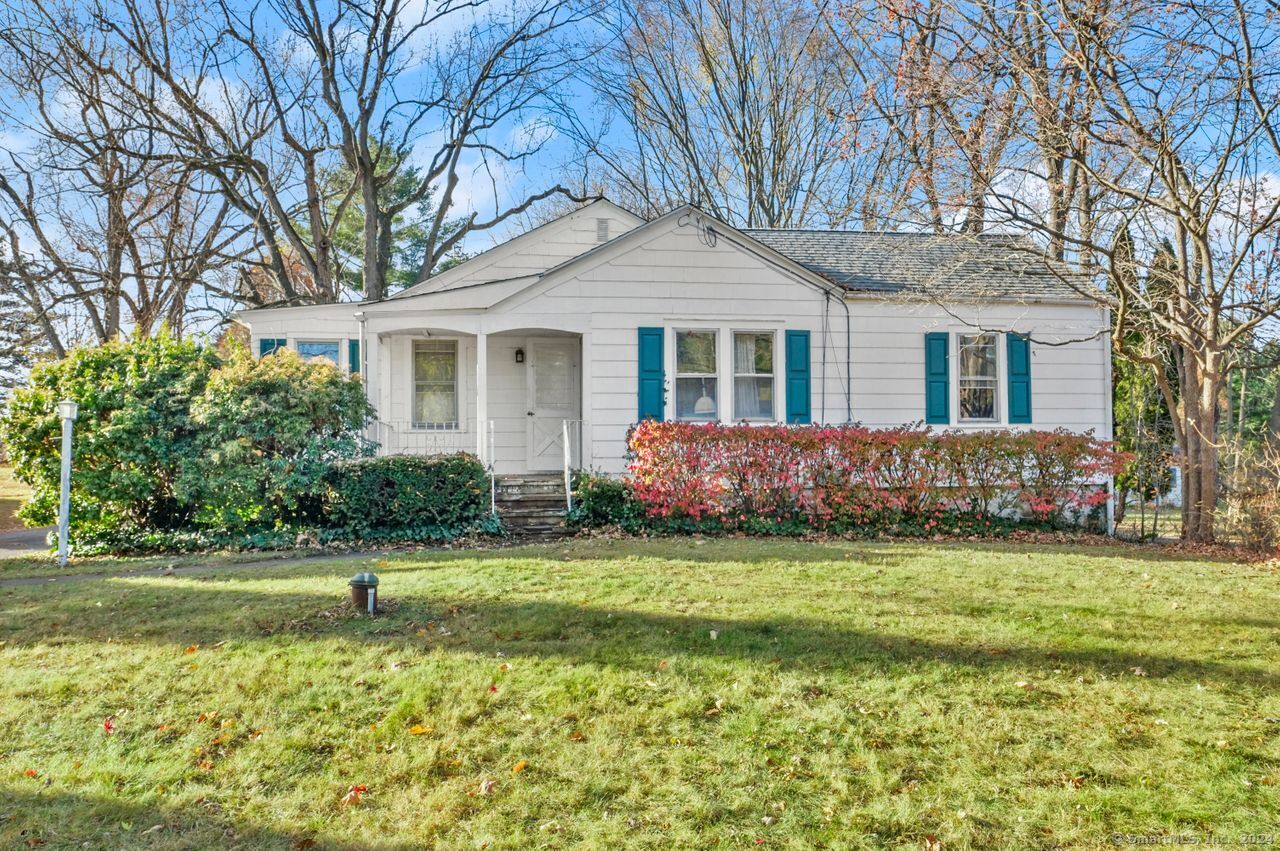 a front view of a house with a garden