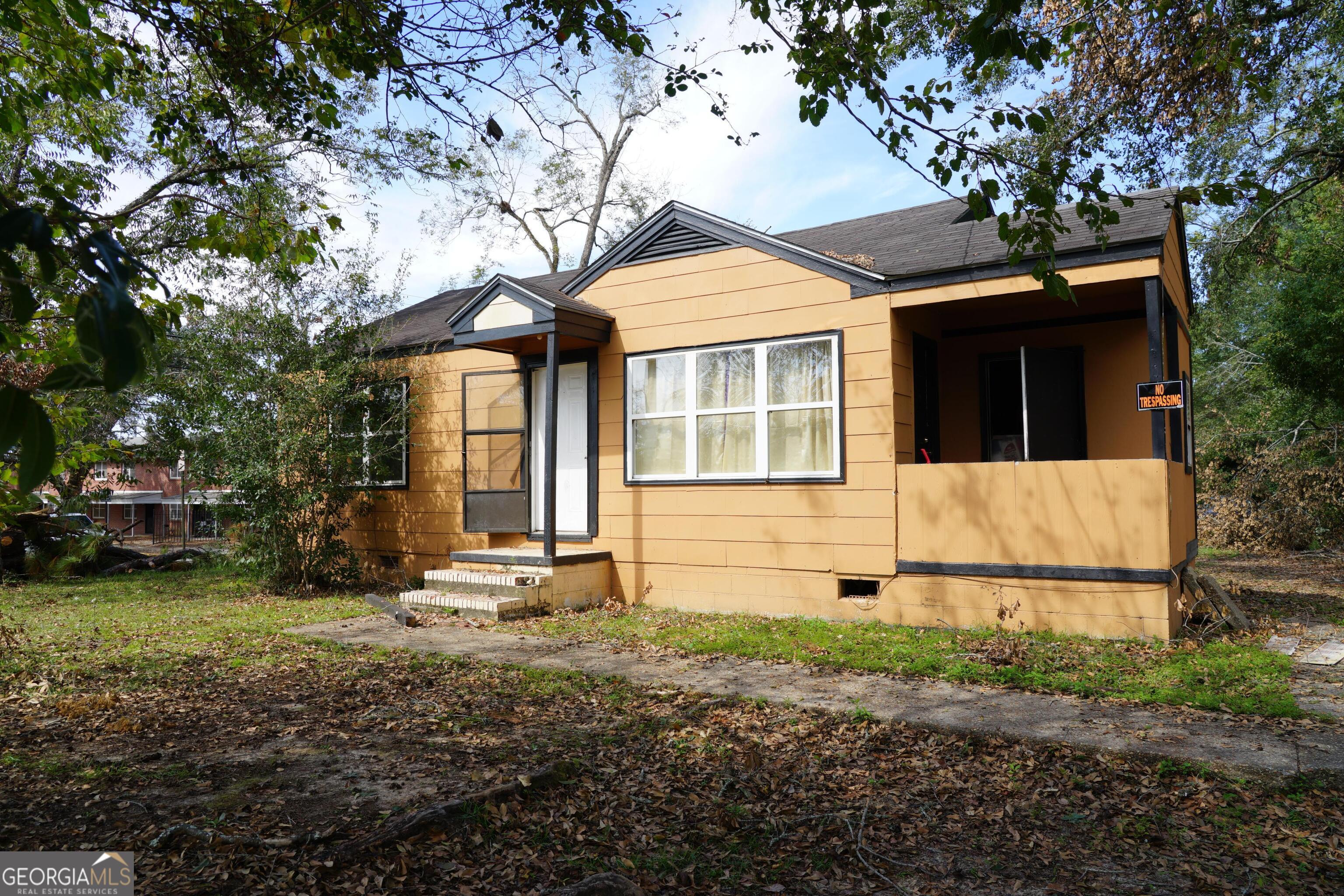 a house with trees in the background