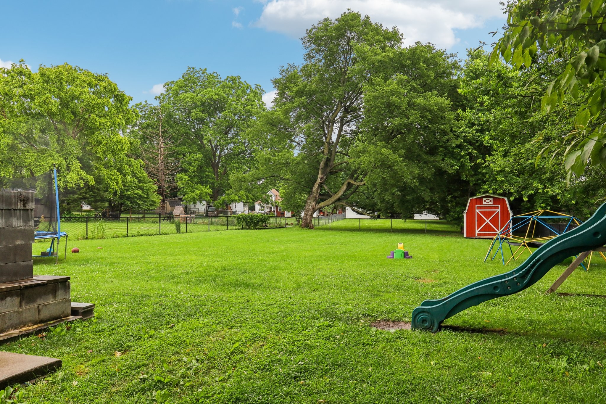 a view of a park with large trees