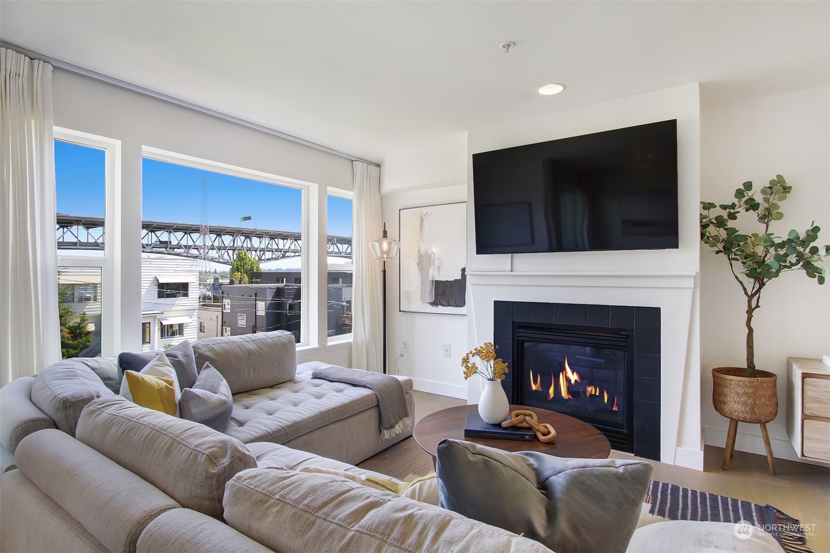 a living room with furniture a flat screen tv and a fireplace