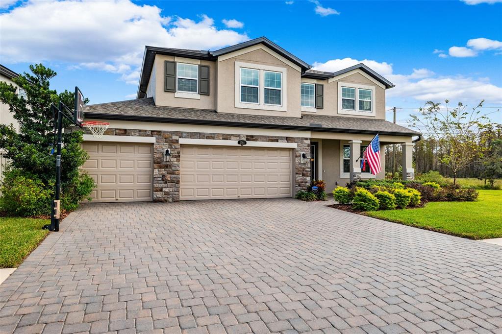 a front view of a house with a yard and garage