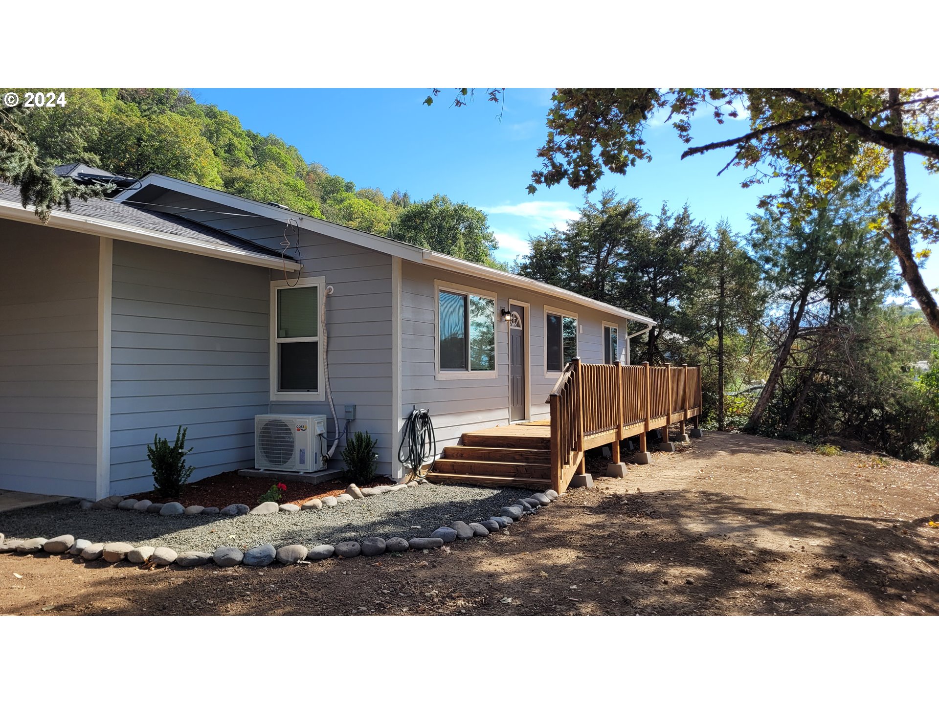 a backyard of a house with wooden fence and trees