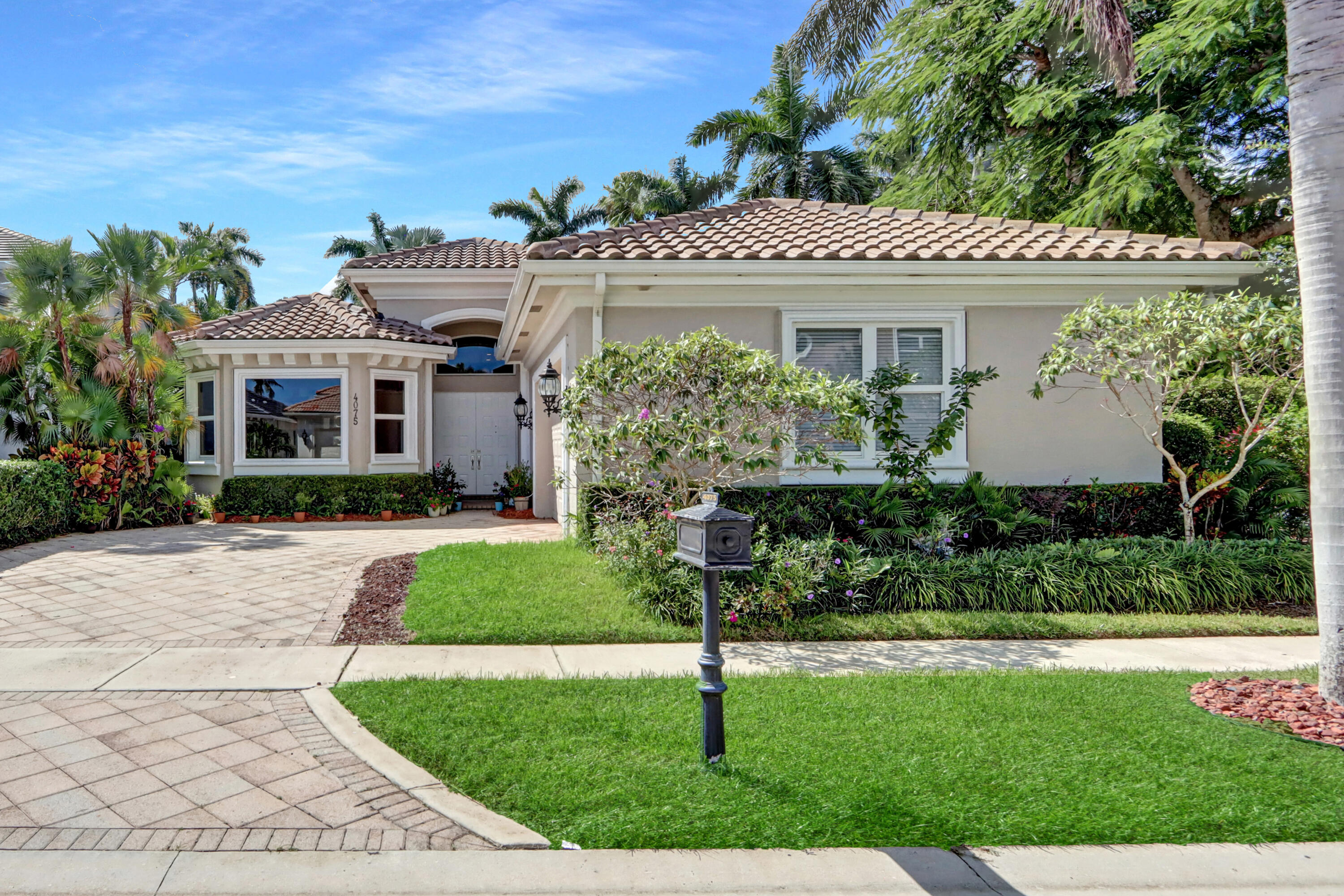 a front view of a house with a garden