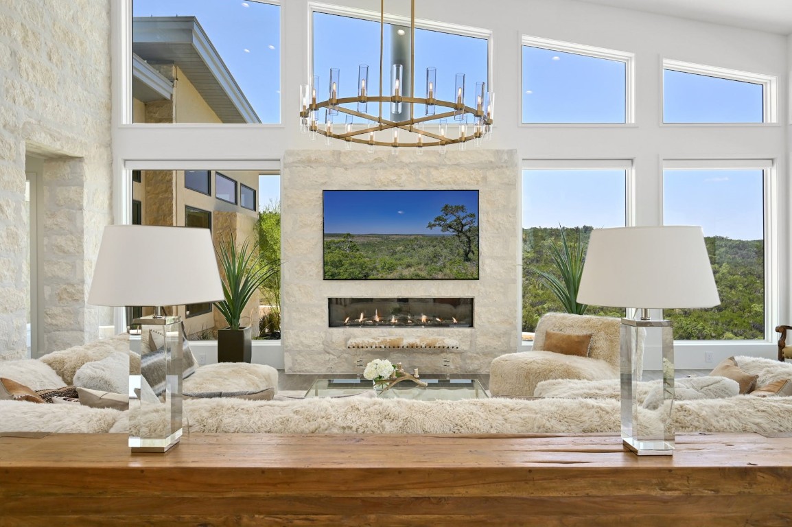 a living room with fireplace furniture and a floor to ceiling window