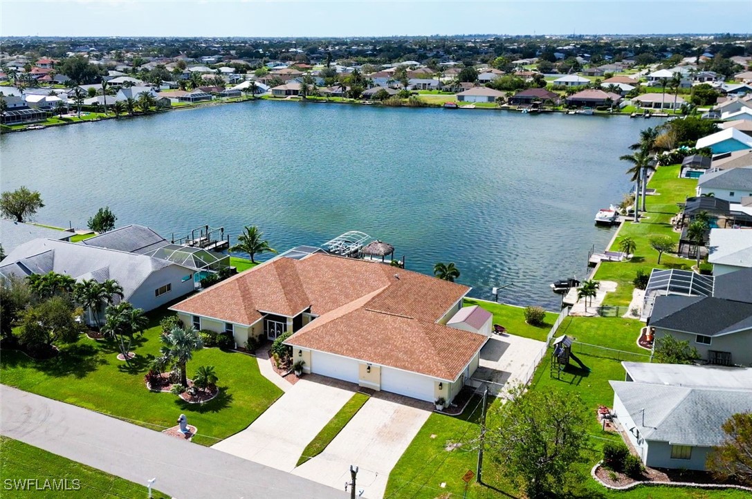 an aerial view of a house with a lake view