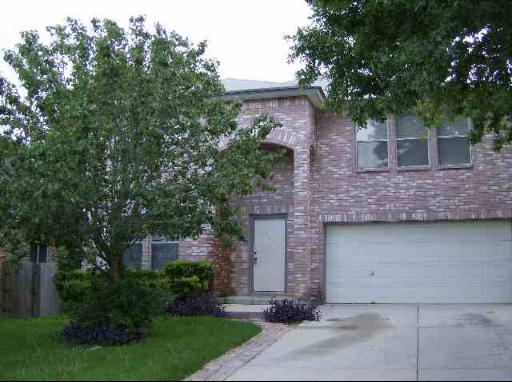 front view of a house with a tree