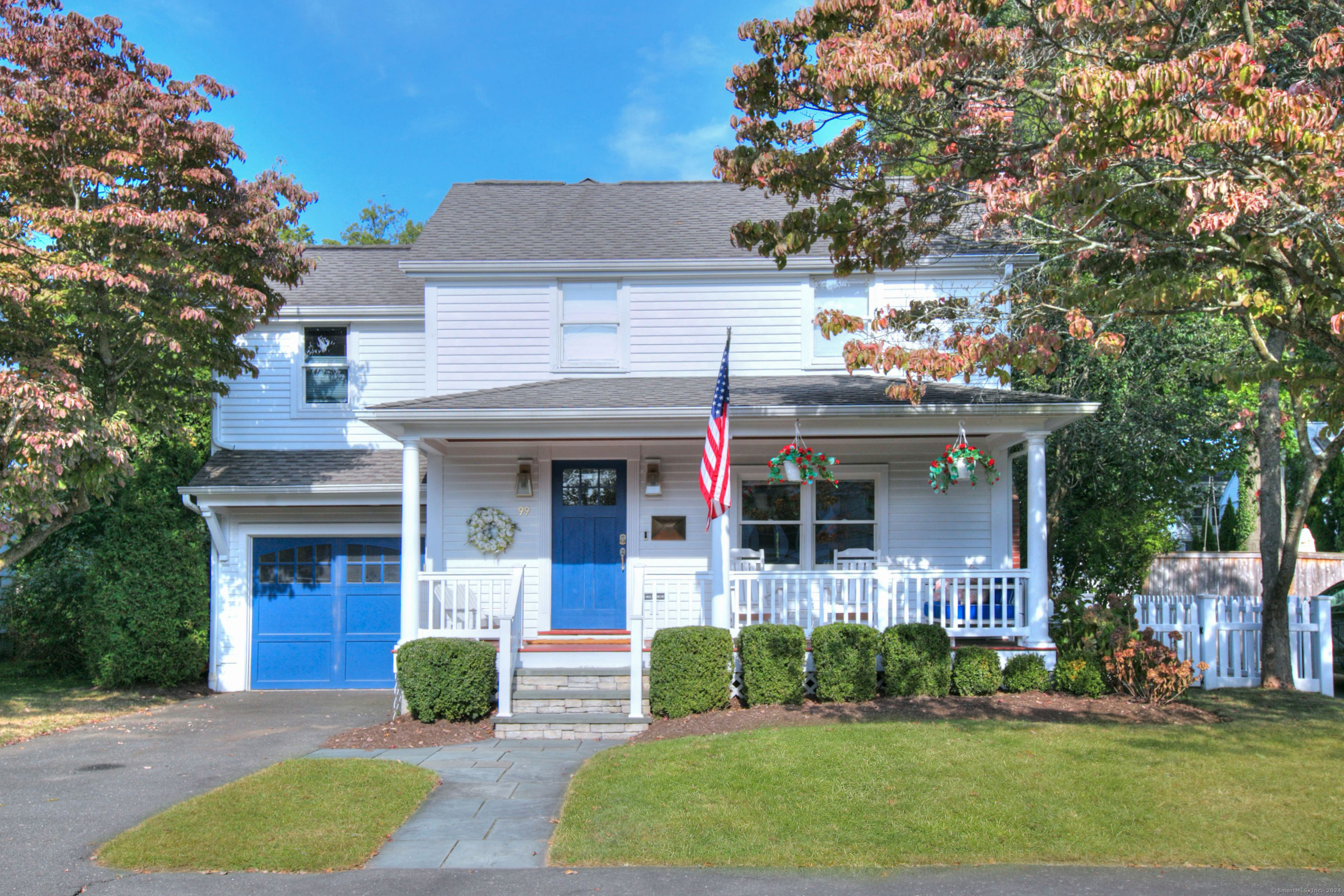 a front view of a house with a yard and potted plants