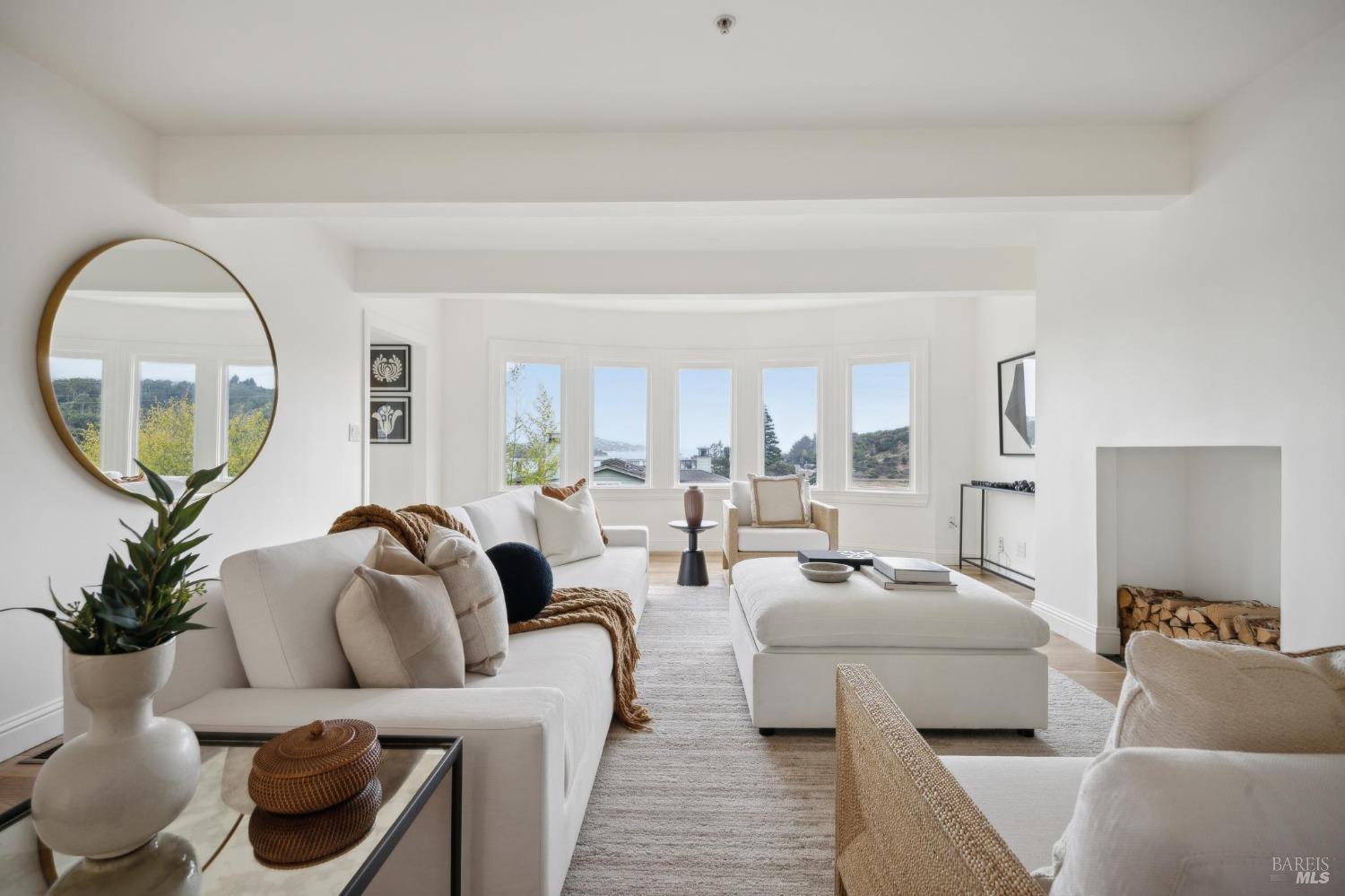 a living room with furniture and a large mirror