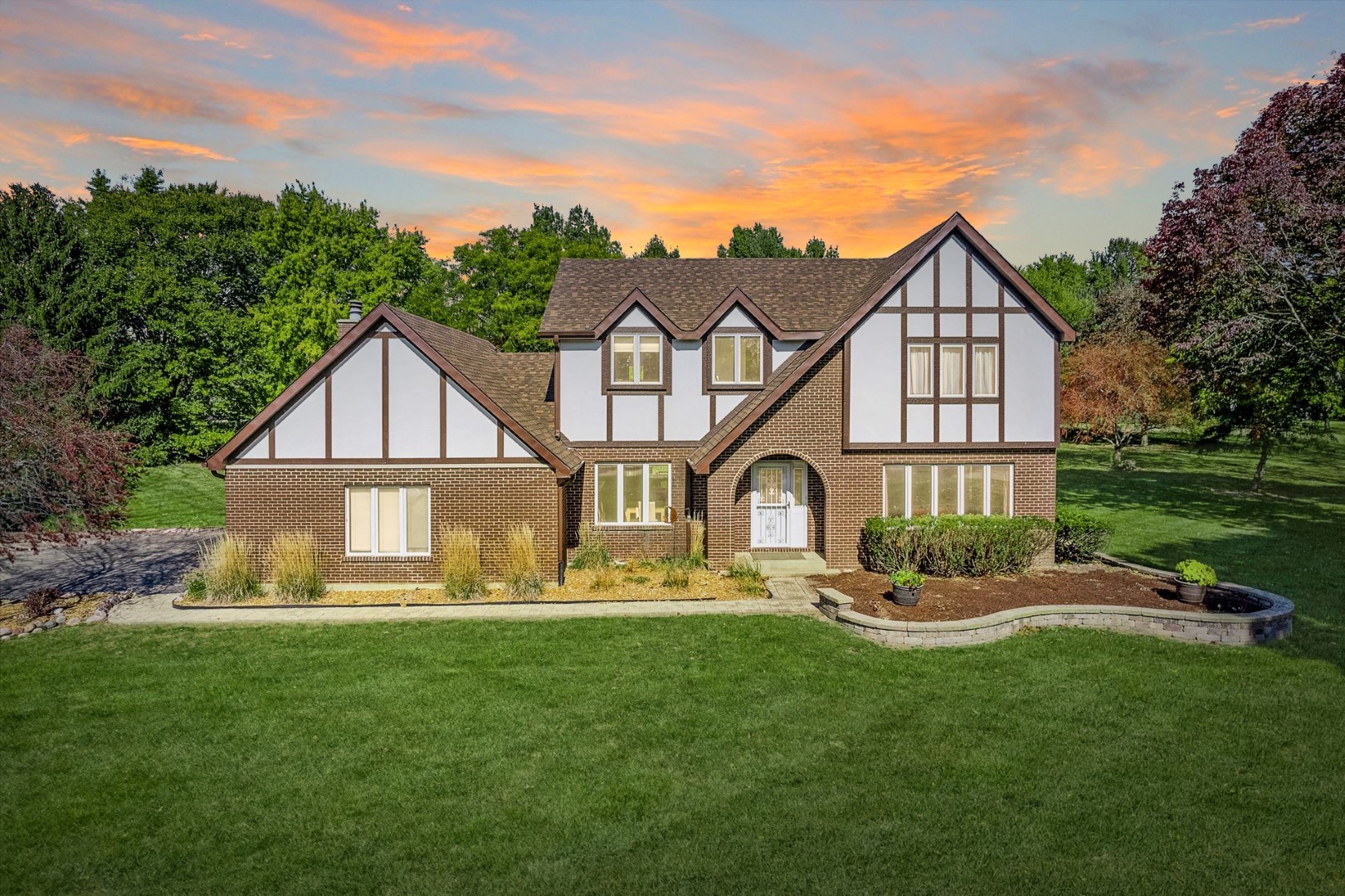 a front view of house with yard and green space