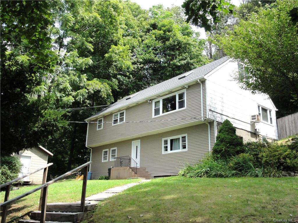 a front view of house with yard and green space