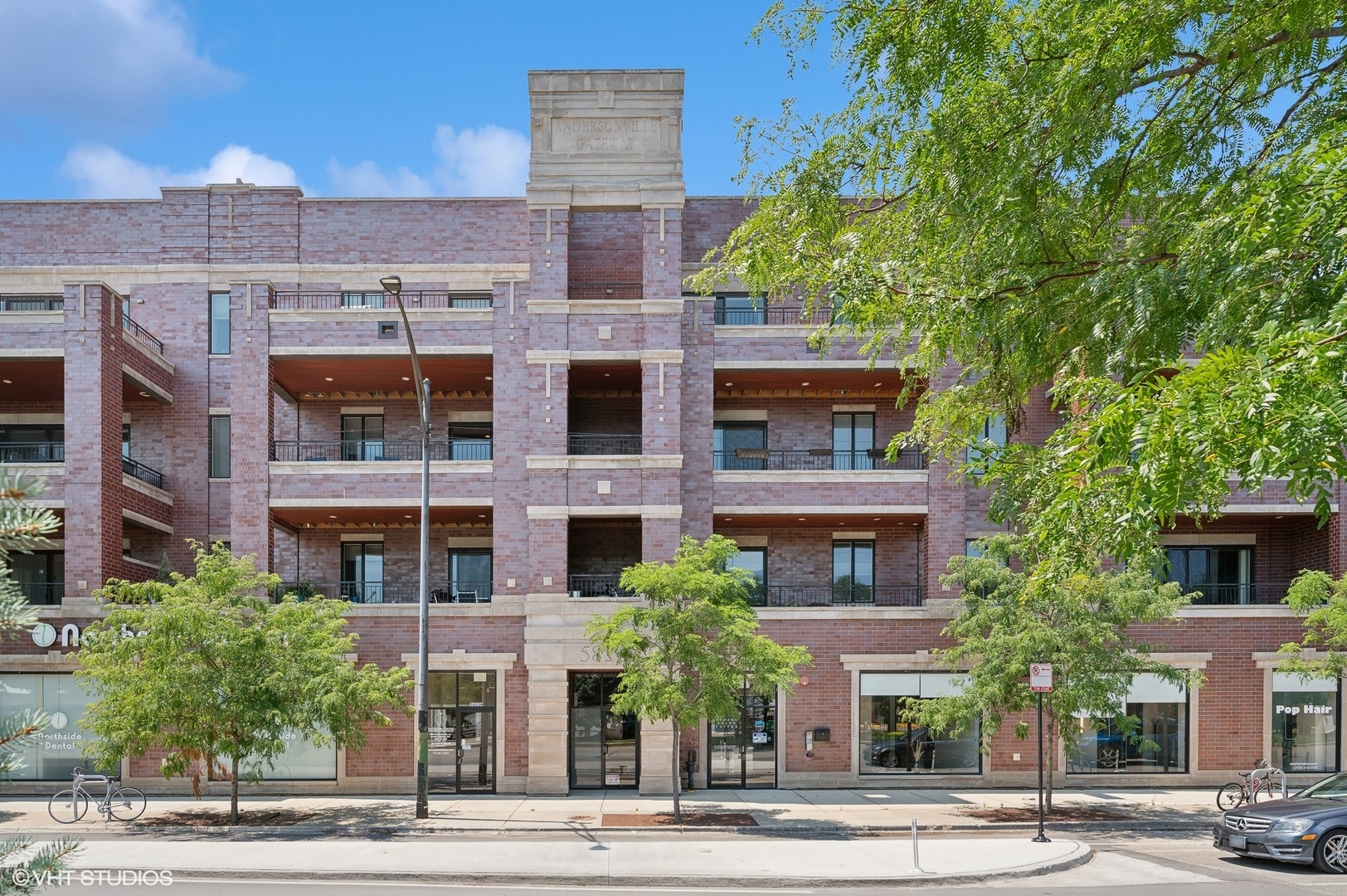 a front view of a multi story building with a yard