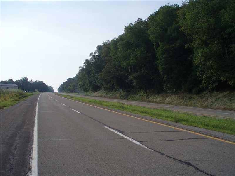 a view of a field of grass and trees