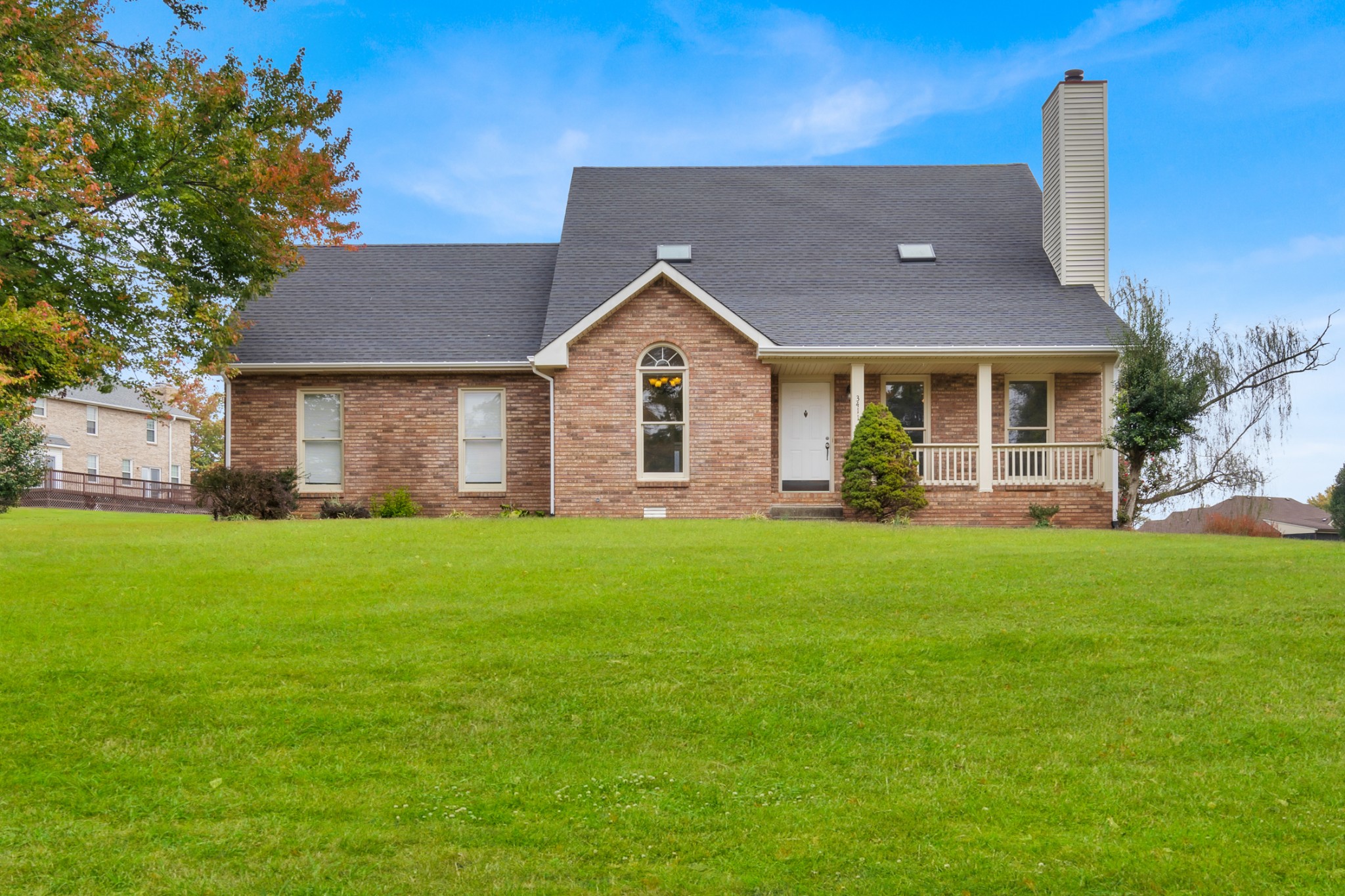 a front view of house with yard and green space