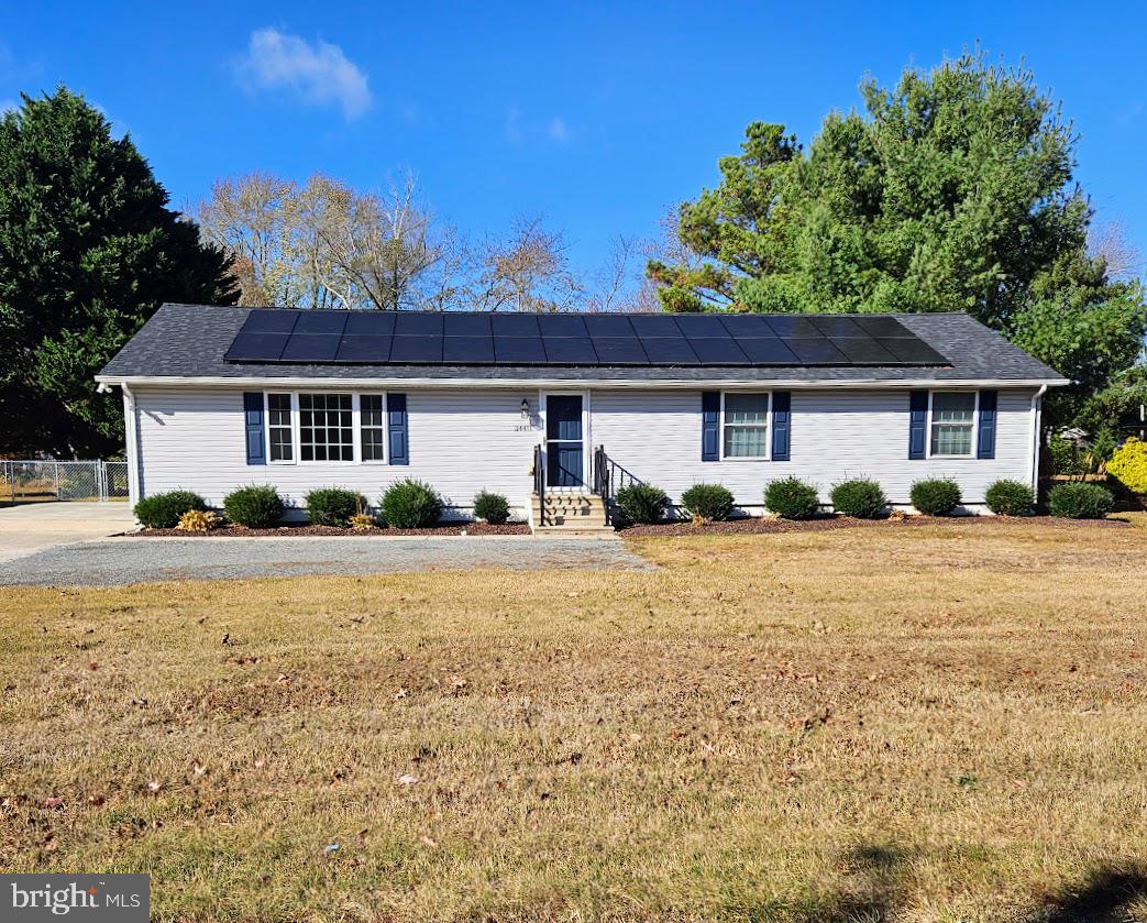 a front view of a house with yard and green space