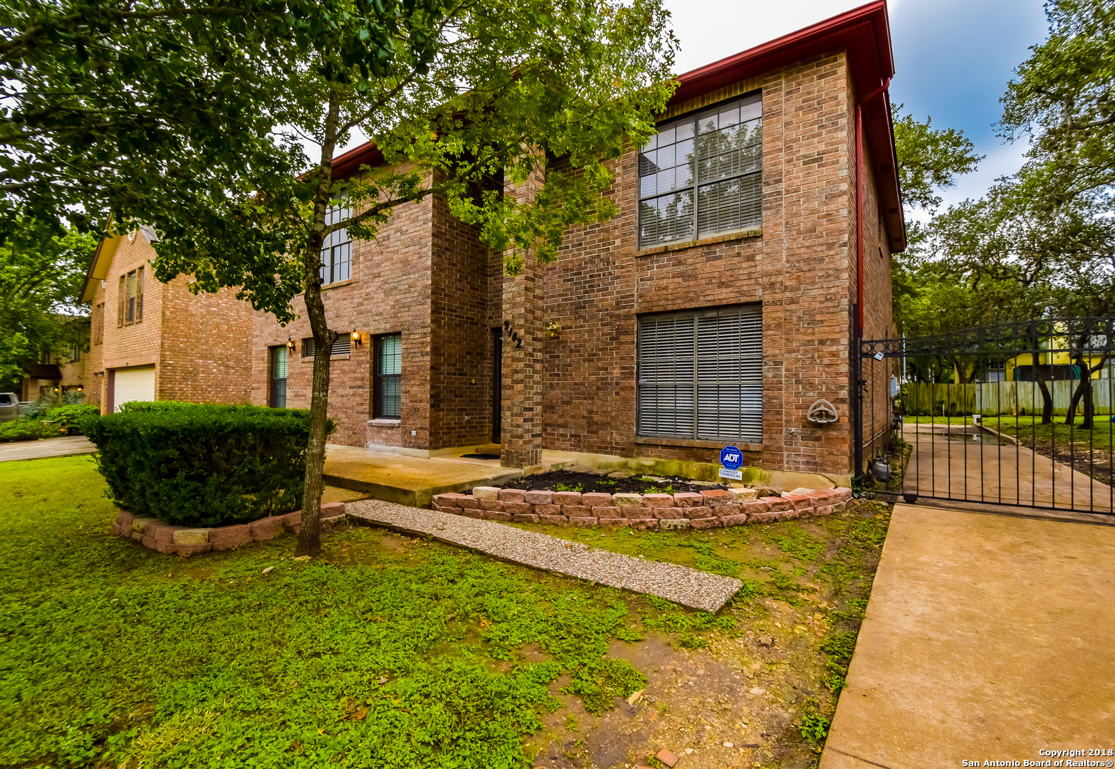 a view of house with backyard space and garden